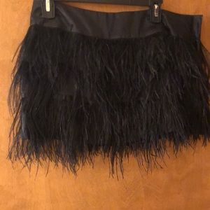 Black feather mini skirt via Bebe